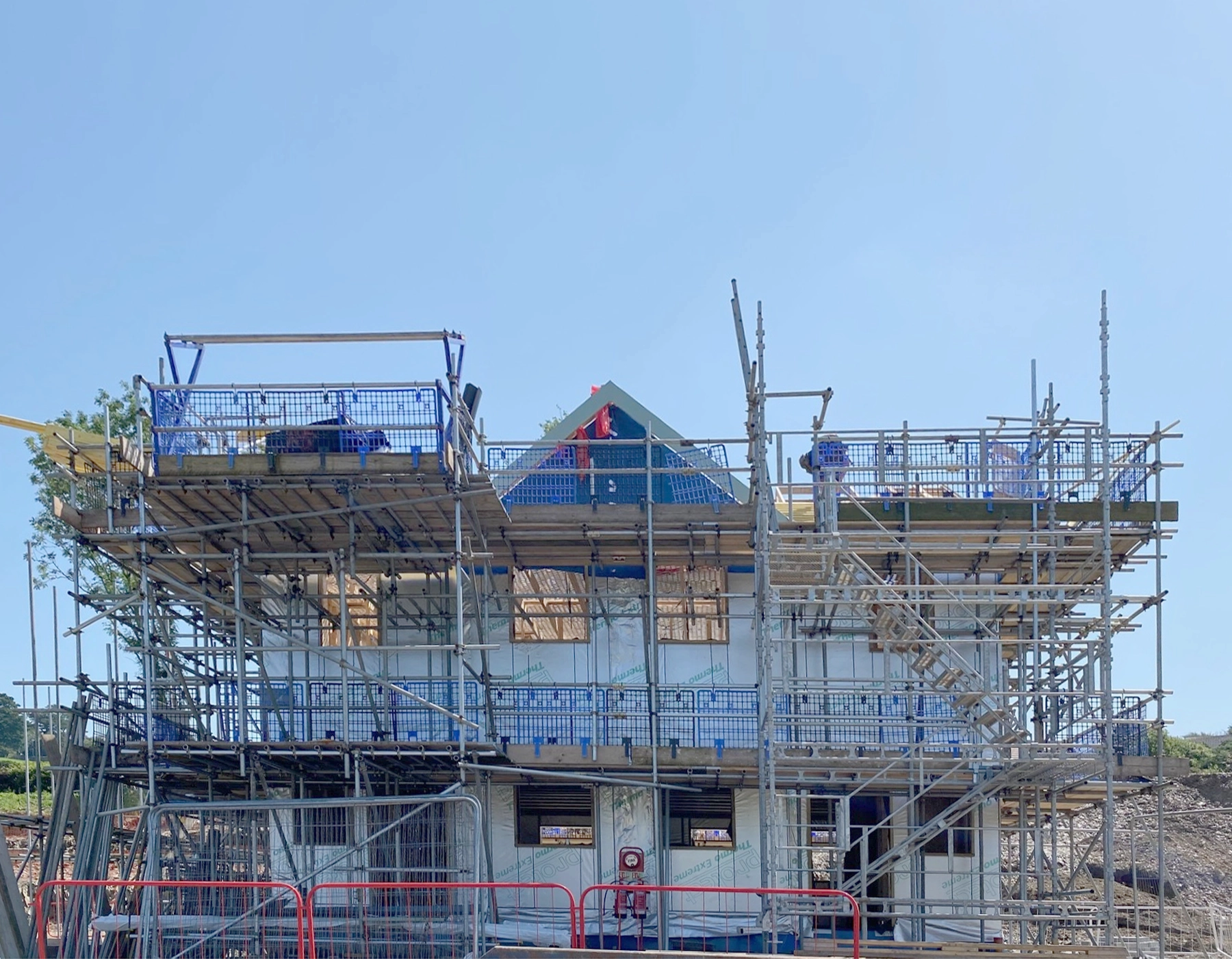 Building work in progress at the Bicclescombe site.  A phiotograph of the front of one of the new blocks, surrounded by scaffolding.